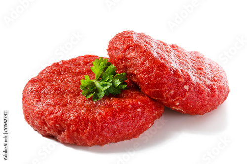 Photo: Raw beef and vegetables on white background Raw beef and vegetables on white background