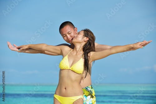 Photo: happy young couple enjoying summer on beach happy young couple enjoying summer on beach