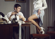 Young sexy woman shows a leg for business man