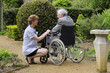 Nurse caring for man sitting in a wheelchair