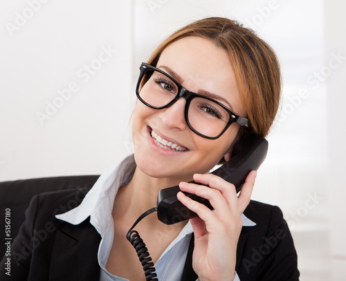 Photo: Businesswoman Talking On Telephone Businesswoman Talking On Telephone