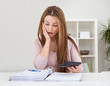 Young Woman Calculating Bills