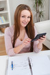 Young Woman Calculating Bills