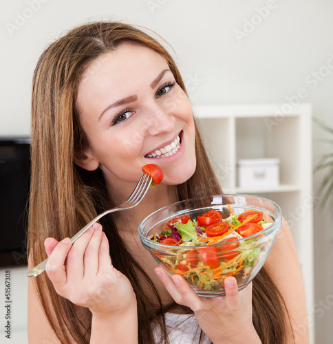 Photo: Young Woman Eating Salad Young Woman Eating Salad