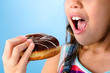 Happy kid eating a doughnut