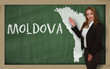 Teacher showing map of moldova on blackboard