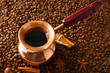 Pot of coffee on coffee beans background