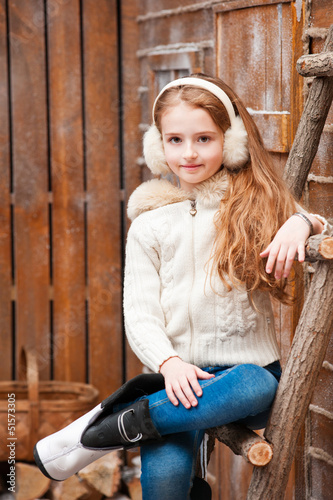 Photo: Beautiful little girl on the wooden porch Beautiful little girl on the wooden porch
