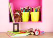 Photo: Colorful pencils in pails on shelf on beige background Colorful pencils in pails on shelf on beige background