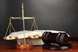 Wooden gavel, golden scales of justice  and books