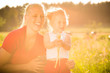 Kid in the meadow blowing dandelion seed