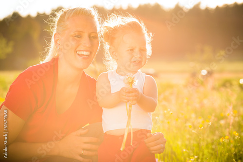 Photo: Kid in the meadow blowing dandelion seed Kid in the meadow blowing dandelion seed