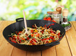 Noodles with vegetables on wok on nature background background