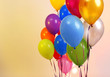 Many bright balloons on orange background