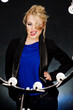 Young beautiful blonde on the dark background in the light of la