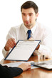 Businesspeople sitting at a table and signing a contract.