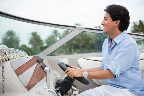 Photo: Man driving a yacht Man driving a yacht