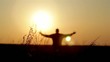 Silhouette of man on the sunrise. Freedom concept.
