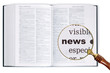 Photo: News through a magnifying glass over Dictionary. News through a magnifying glass over Dictionary.