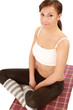A young sportive girl sitting on the floor