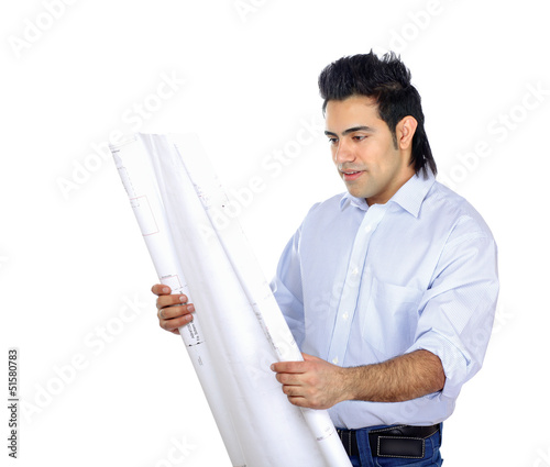 Photo: Pensive young businessman comparing something with drafts Pensive young businessman comparing something with drafts