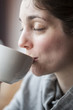 Beautiful Young Woman Holding Her Morning Cup of Coffee