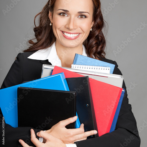 Photo: Businesswoman with folders, on gray Businesswoman with folders, on gray