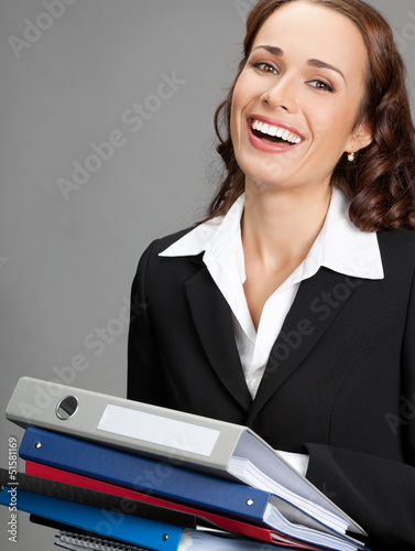 Photo: Businesswoman with folders, on gray Businesswoman with folders, on gray