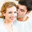 Foto: Cheerful smiling young couple, indoors Cheerful smiling young couple, indoors