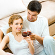 Cheerful couple with glasses of redwine