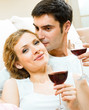 Cheerful couple with glasses of redwine