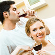 Cheerful couple with glasses of redwine