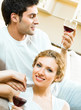 Cheerful couple with glasses of redwine