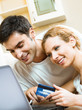 Photo: Cheerful couple paying by plastic card Cheerful couple paying by plastic card