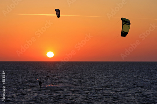 Photo: kitesurfers at sunset kitesurfers at sunset