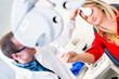 Optometry concept - pretty young woman having her eyes examined