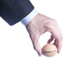Egg with inscription Stability between fingers. Concept of the c