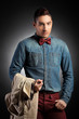 Attractive male model holding coat and posing