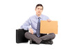 Broke businessman begging with a piece of cardboard