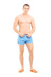 Full length portrait of a handsome muscular man posing in swimsu