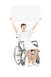 Male patient in a wheelchair holding a blank panel