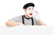 Mime dancer gesturing and shouting and standing on a panel