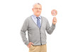 Senior gentleman holding a colorful lollipop
