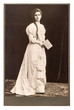 young woman in vintage dress posing with bible book