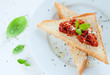 Toast with red tomato italian pesto and fresh basil