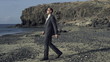 Businessman relaxing on the beach, super slow motion