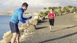 Female jogger with personal trainer, super slow motion