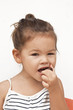 Photo: Asian little girl eating chocolate Asian little girl eating chocolate