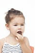 Photo: Asian little girl eating chocolate Asian little girl eating chocolate