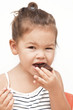 Photo: Asian little girl eating chocolate Asian little girl eating chocolate